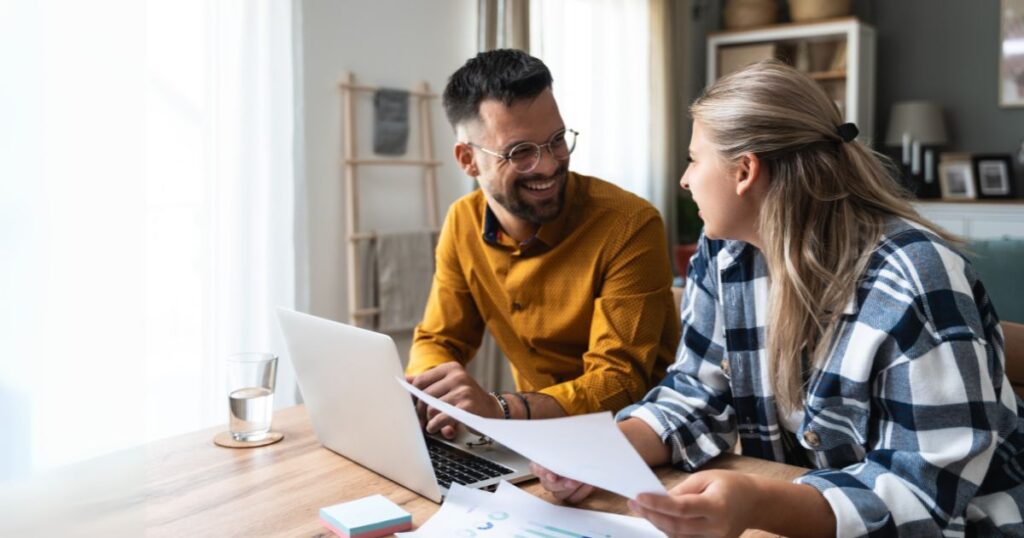 Young couple on laptop with paperwork