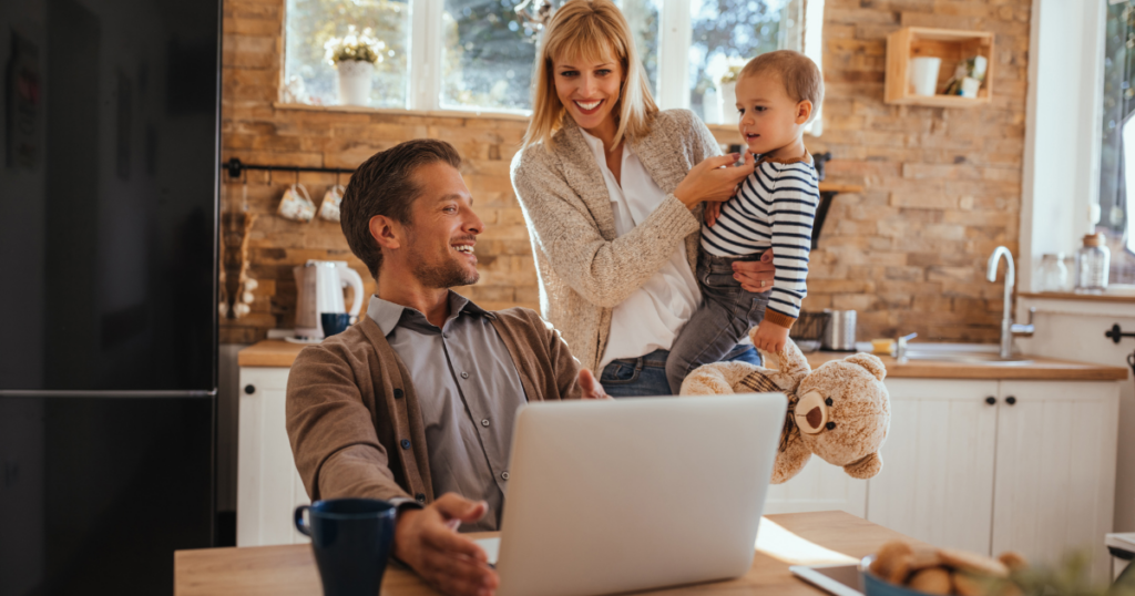 family looking at laptop